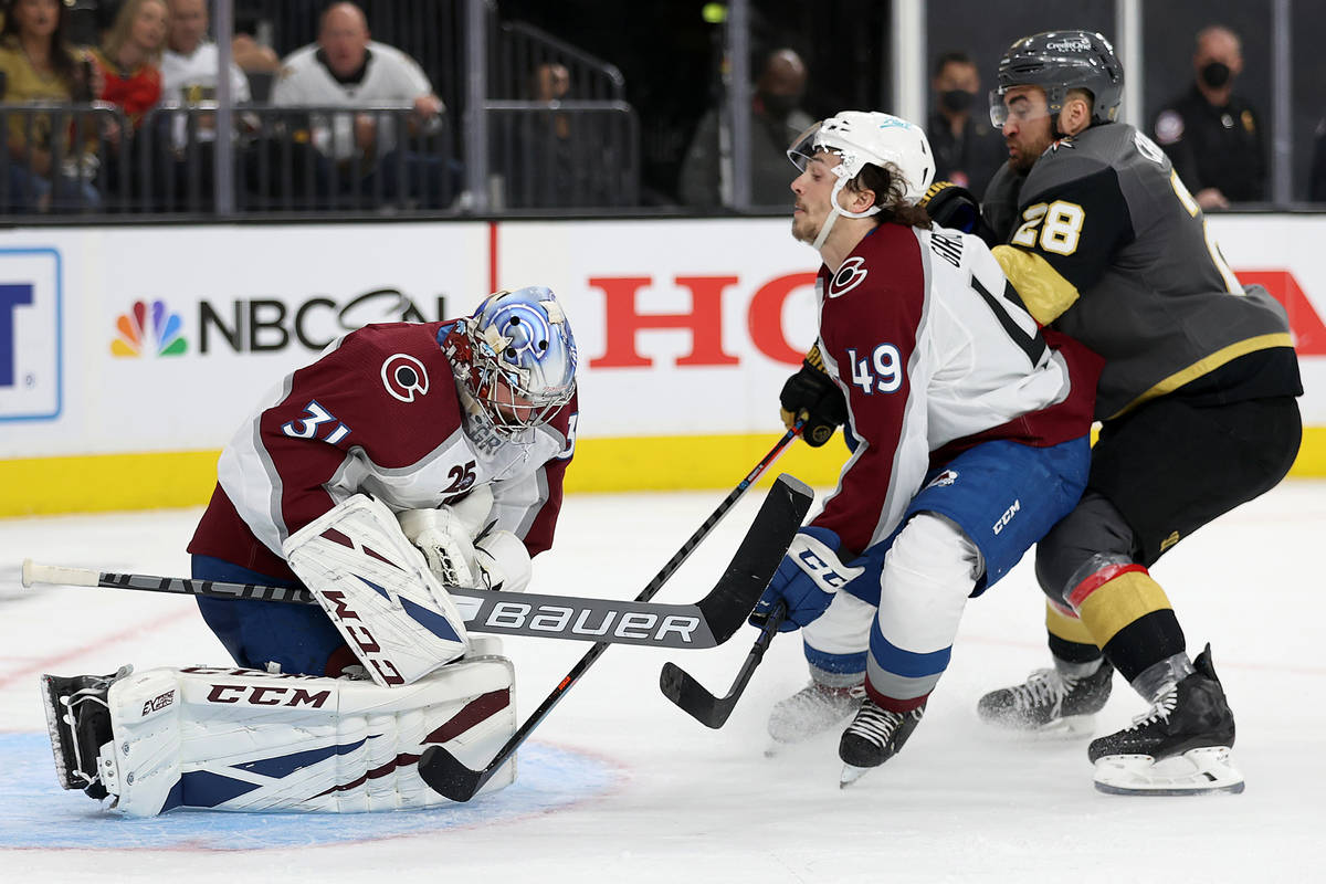 Colorado Avalanche goaltender Philipp Grubauer (31) and defenseman Samuel Girard (49) defend th ...