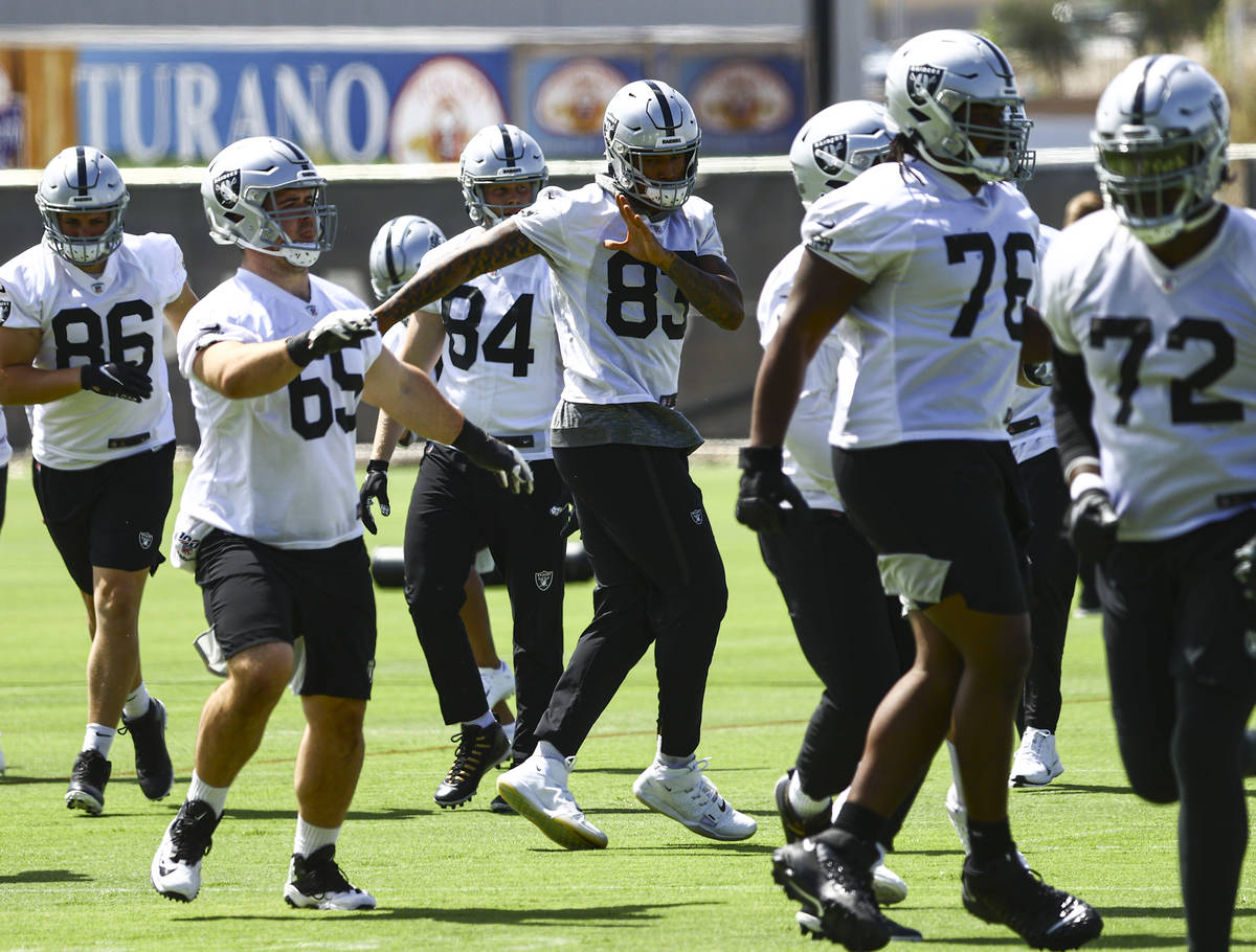 Raiders tight end Darren Waller (83) warms up with teammates during NFL football practice at Ra ...