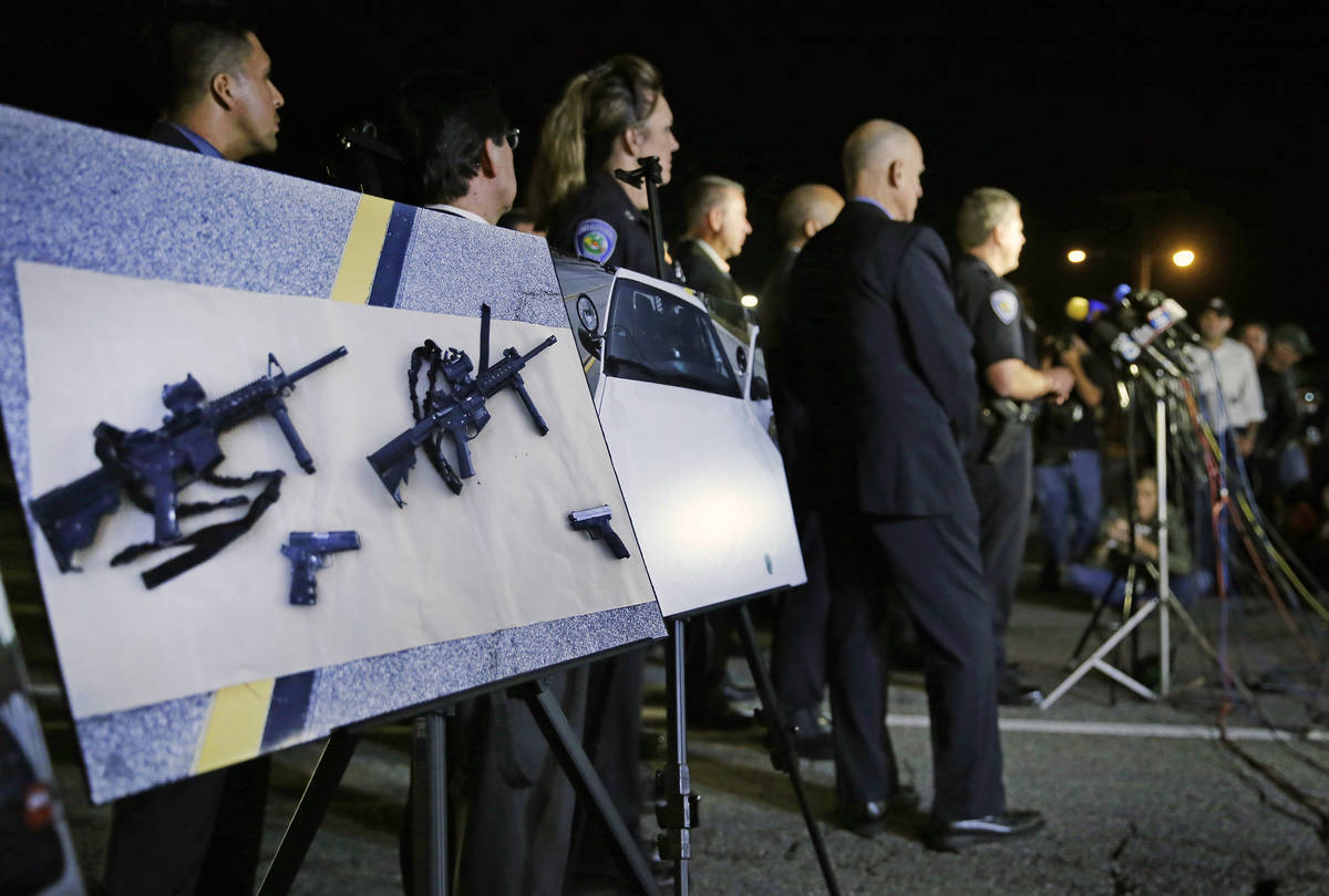 In this Thursday, Dec. 3, 2015, file photo, police crime photos of assault rifles and handguns ...