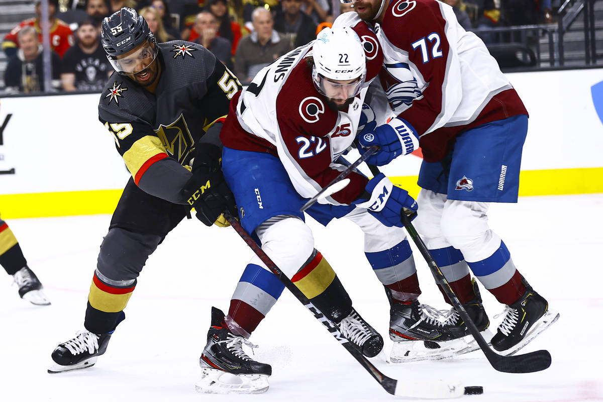 Golden Knights' Keegan Kolesar (55) battles for the puck against Colorado Avalanche's Conor Tim ...