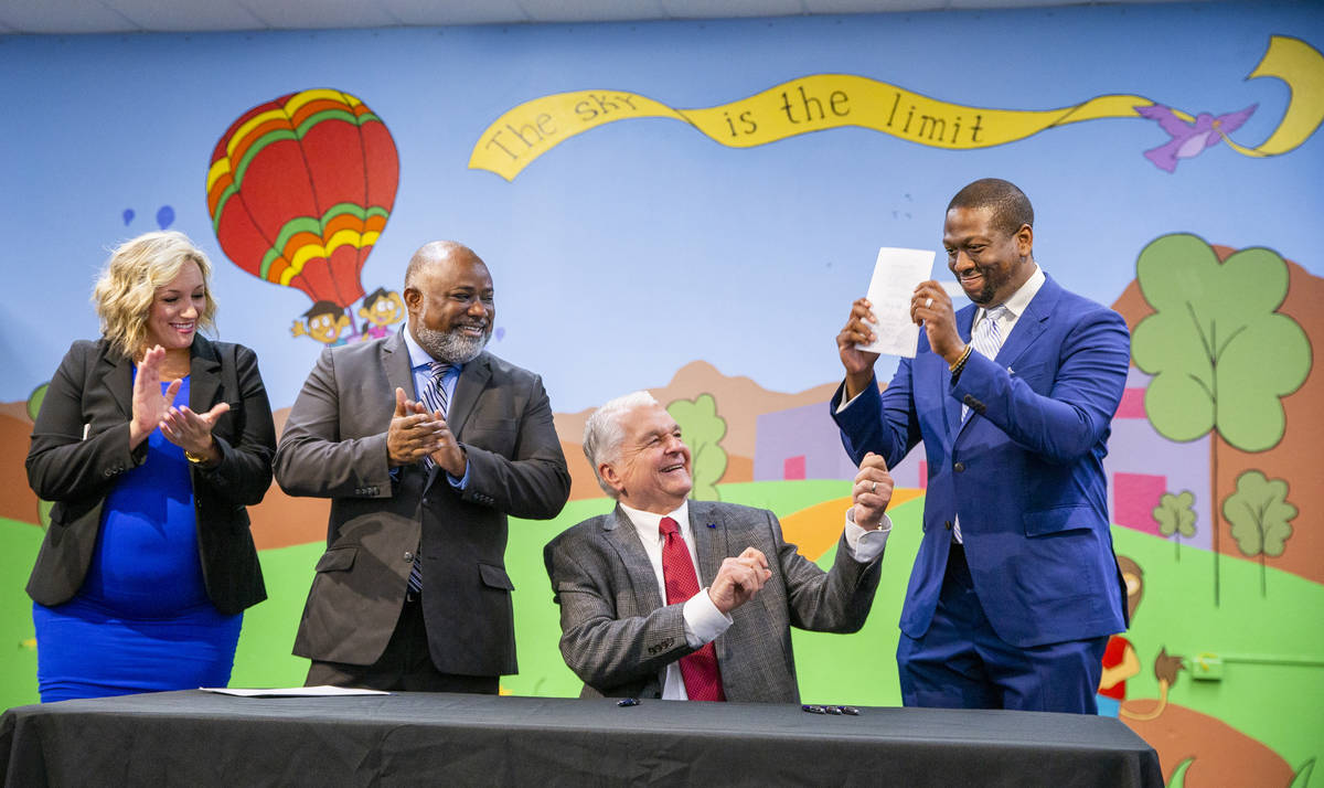 Gov. Steve Sisolak hands previously signed Assembly Bill 495 to President of the Nevada Mining ...