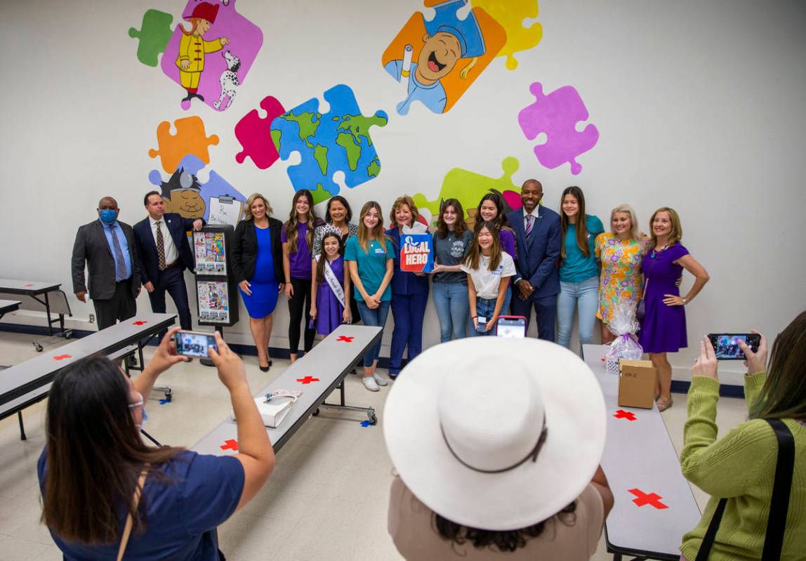 Attendees gather for a photo during a ceremony for four bill signings at Fay Herron Elementary ...