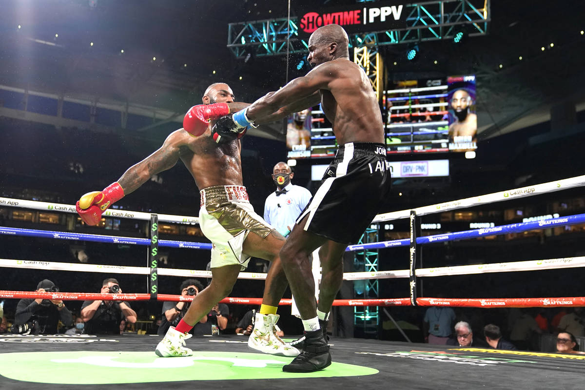 Former NFL wide receiver Chad Johnson, right, and Brian Maxwell fight during an exhibition boxi ...