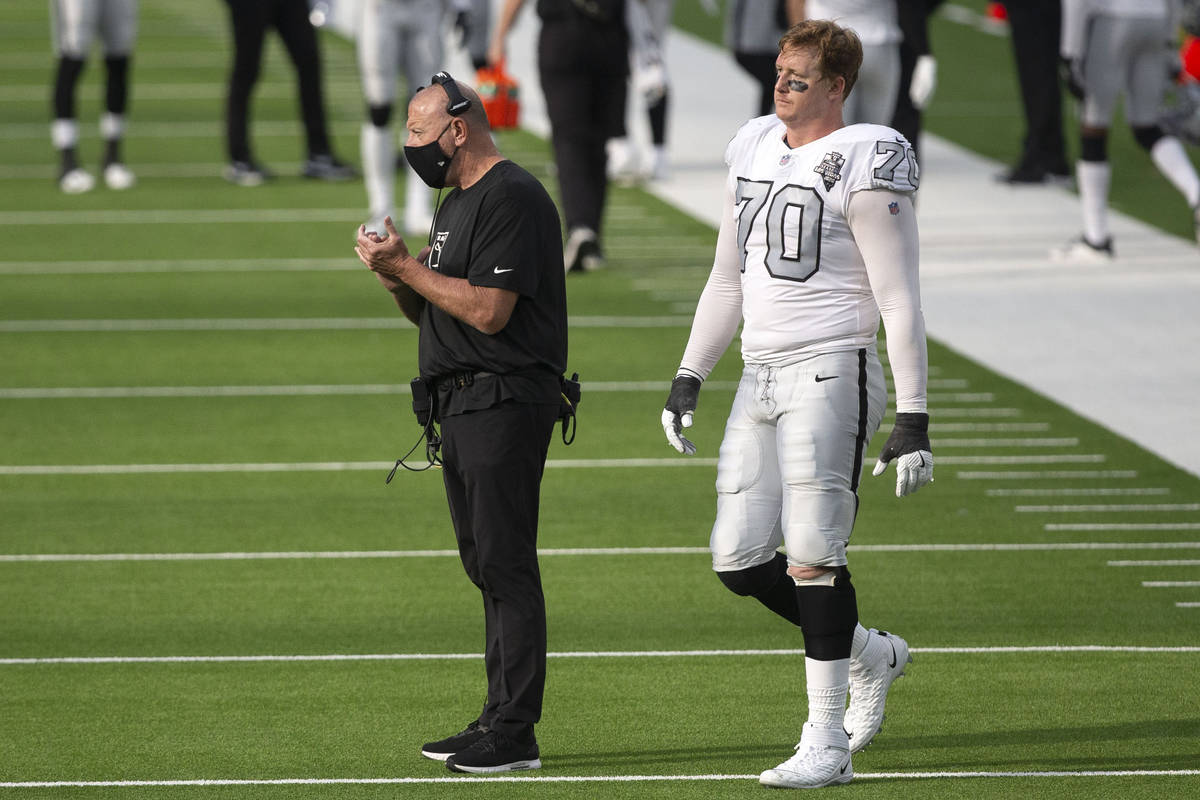 Las Vegas Raiders offensive line coach Tom Cable, left, claps after the team scores a field goa ...