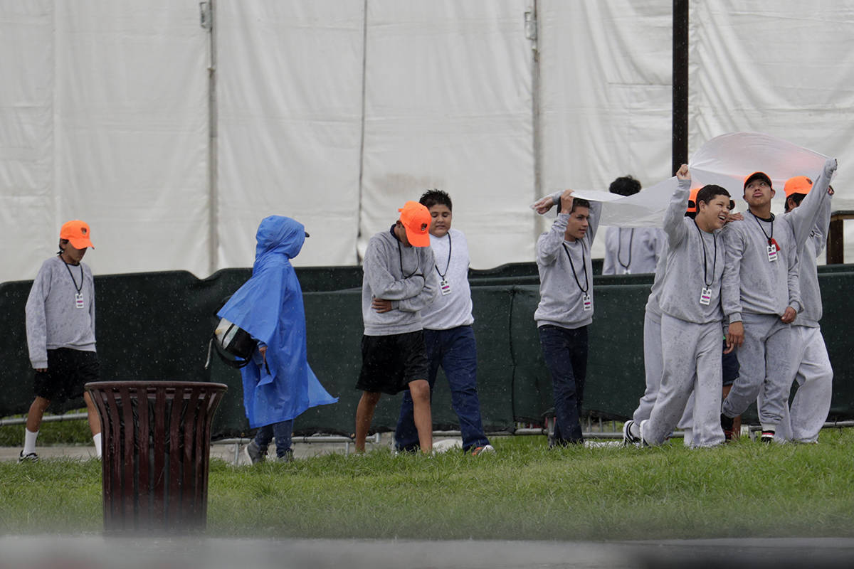 Migrant children walk on the grounds of the Homestead Temporary Shelter for Unaccompanied Child ...