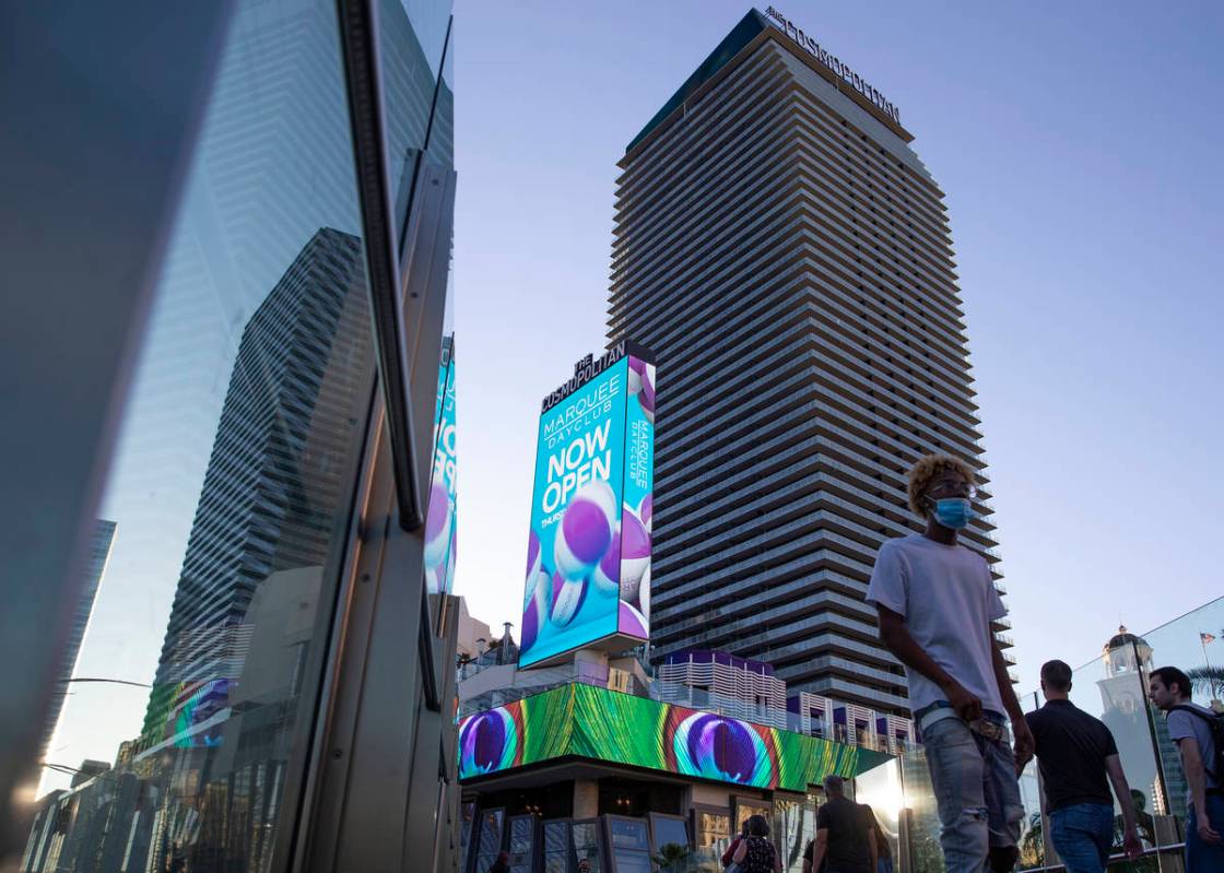 Visitors to the Las Vegas Strip cross a pedestrian bridge outside Cosmopolitan of Las Vegas on ...