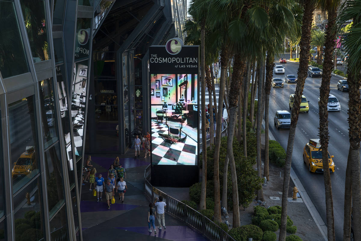 Pedestrians and traffic pass Cosmopolitan of Las Vegas on Wednesday, June 9, 2021 in Las Vegas. ...