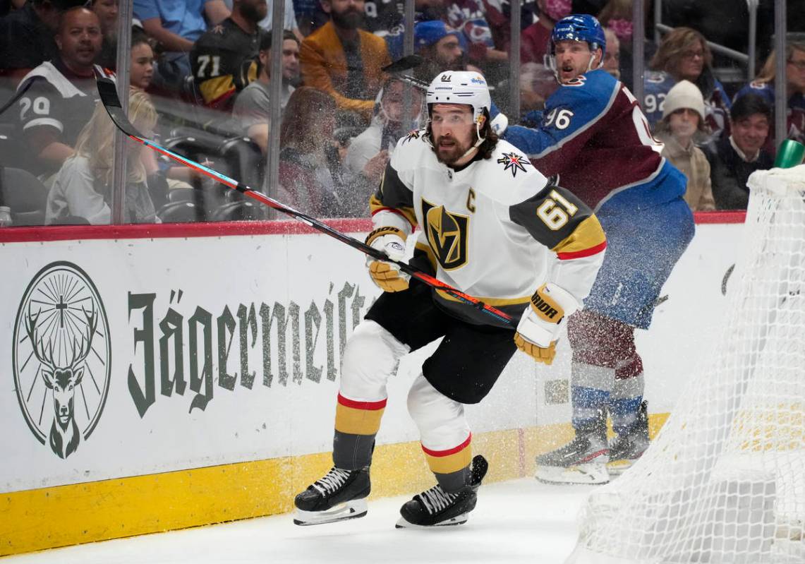 Vegas Golden Knights right wing Mark Stone, front, pursues the puck after checking Colorado Ava ...