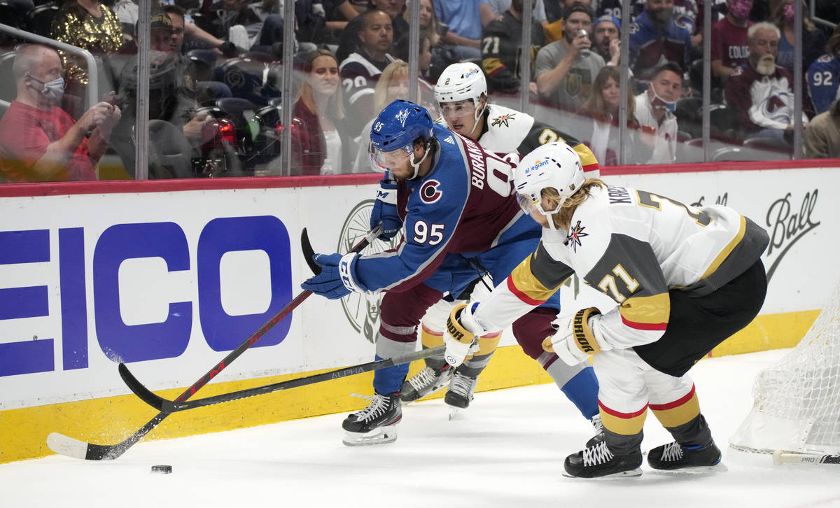 Colorado Avalanche left wing Andre Burakovsky drives between Vegas Golden Knights defenseman Za ...