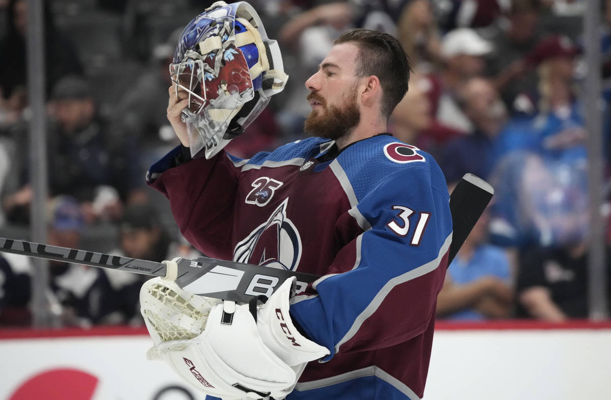 Colorado Avalanche goaltender Philipp Grubauer puts on his mask during a timeout in the first p ...