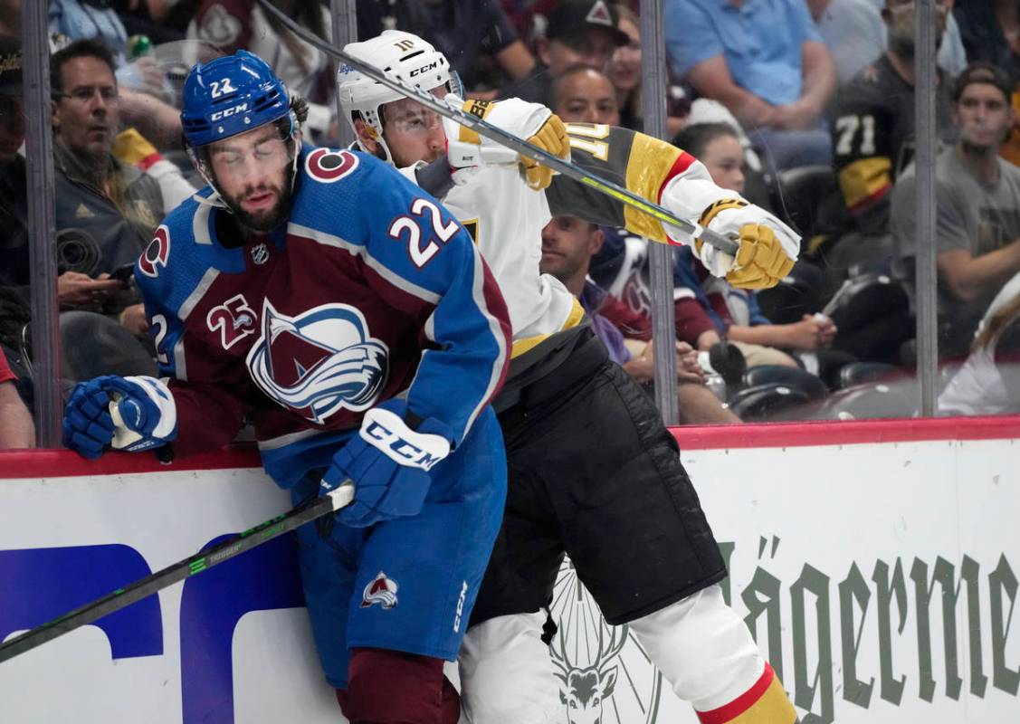 Vegas Golden Knights center Nicolas Roy, right, cheks Colorado Avalanche defenseman Conor Timmi ...