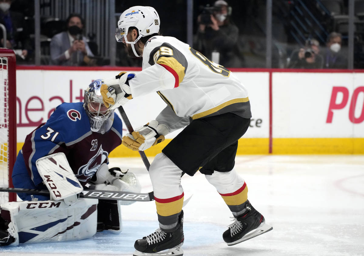 Vegas Golden Knights right wing Alex Tuch, right, scores a goal past Colorado Avalanche goalten ...