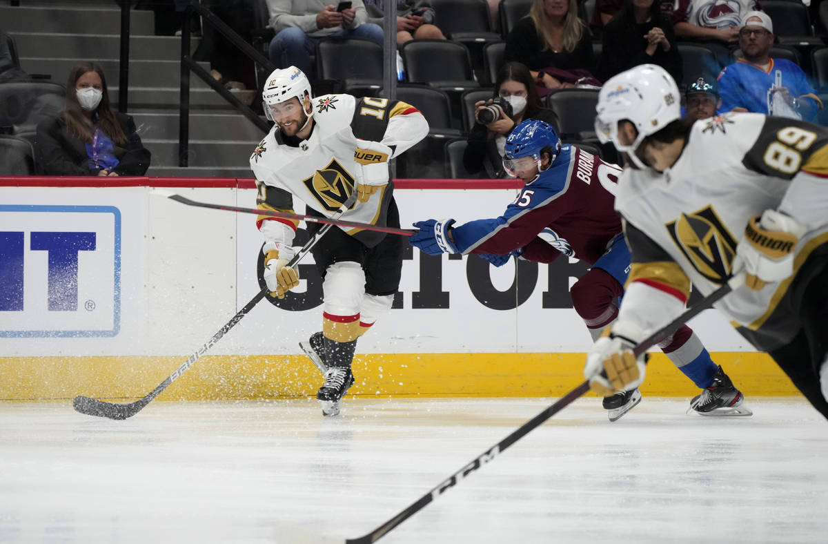 Vegas Golden Knights center Nicolas Roy, left, lifts a pass to right wing Alex Tuch, front, as ...