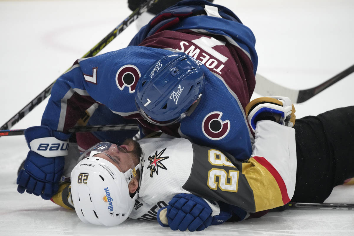 Colorado Avalanche defenseman Devon Toews knocks down Vegas Golden Knights left wing William Ca ...