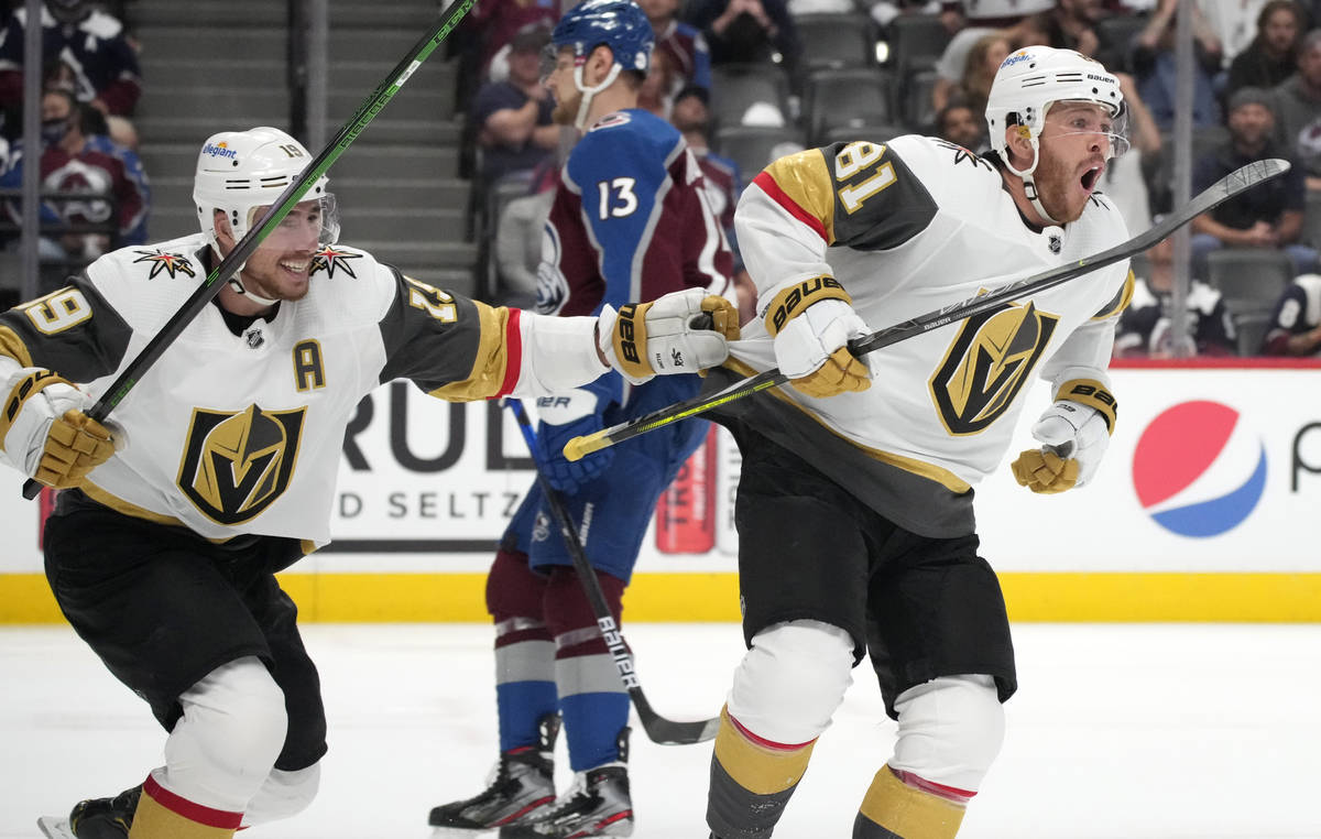 Vegas Golden Knights right wing Reilly Smith, left, celebrates with center Jonathan Marchessaul ...