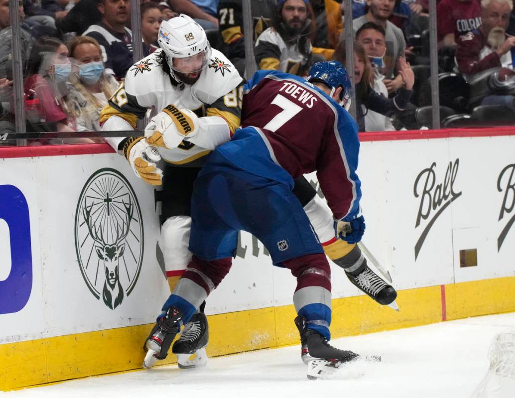 Colorado Avalanche defenseman Devon Toews, right, checks Vegas Golden Knights right wing Alex T ...