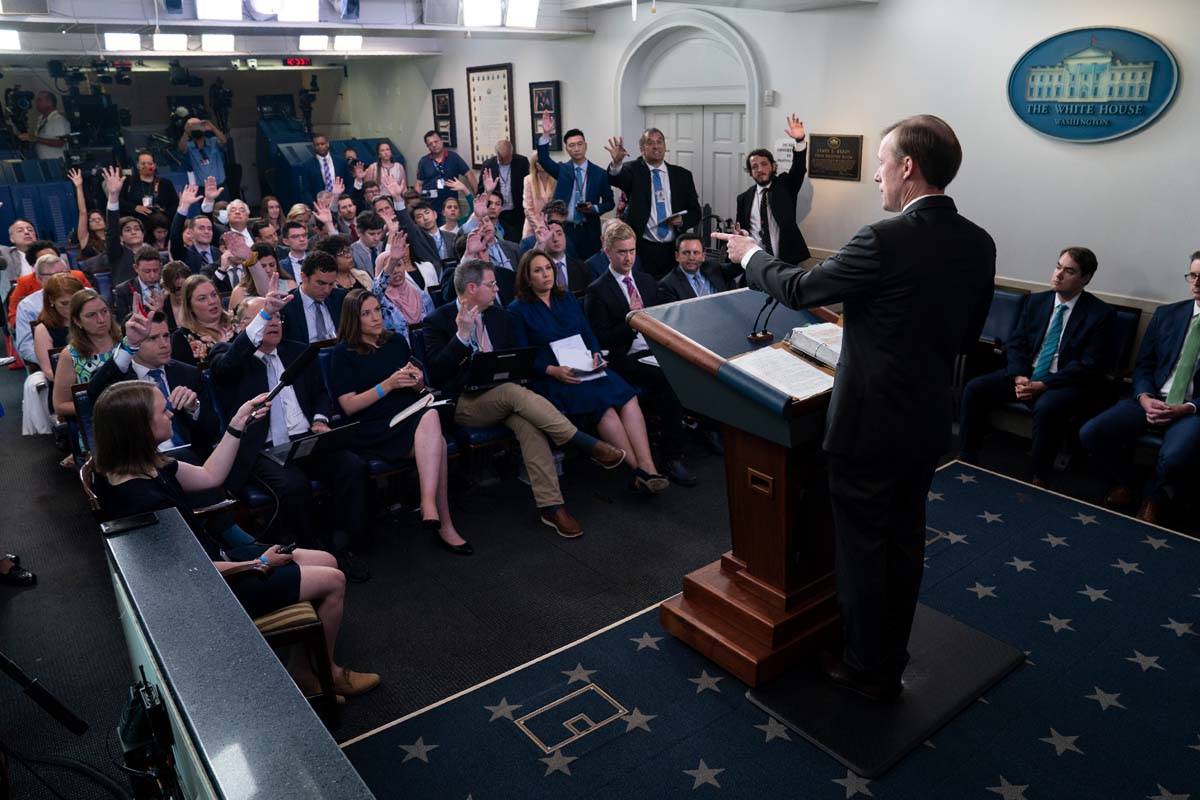 In this June 7, 2021 photo, journalists raise their hands to ask a question as White House nati ...