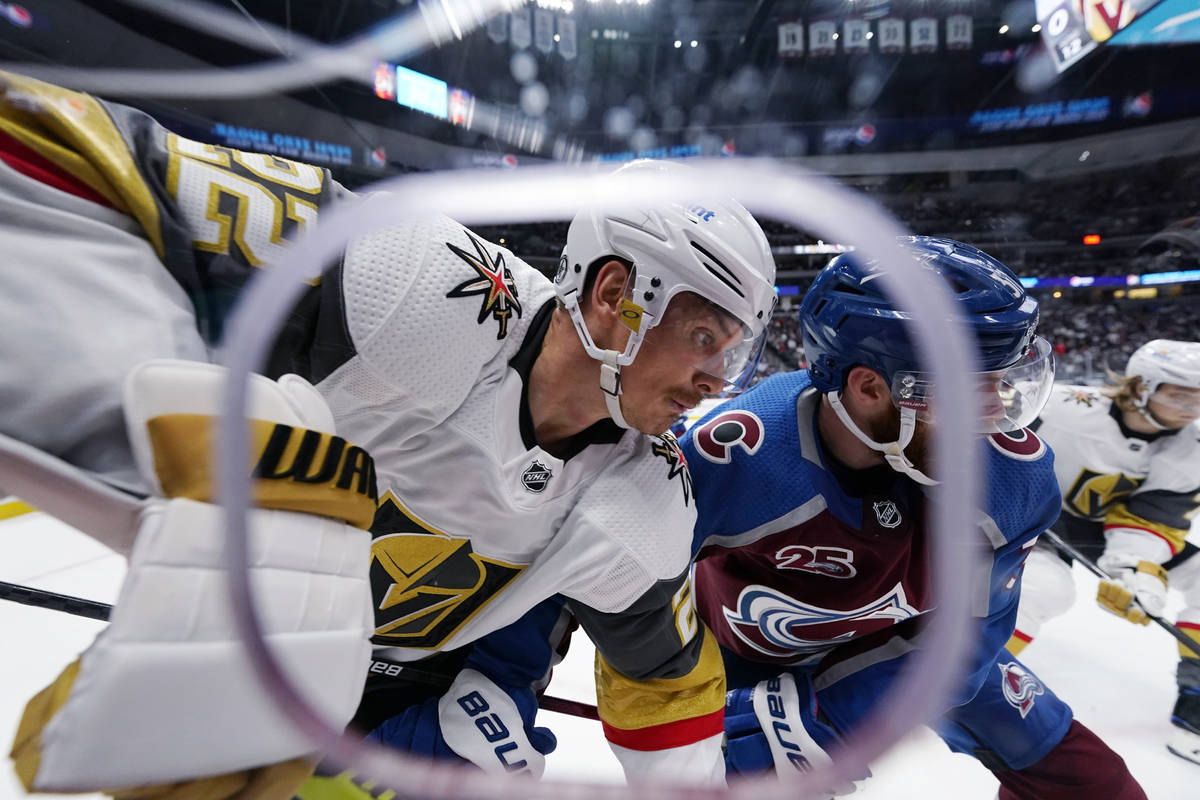 Vegas Golden Knights defenseman Nick Holden, left, and Colorado Avalanche left wing J.T. Comphe ...