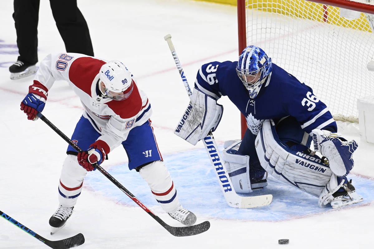 Toronto Maple Leafs goaltender Jack Campbell (36) watches the puck as Montreal Canadiens left w ...