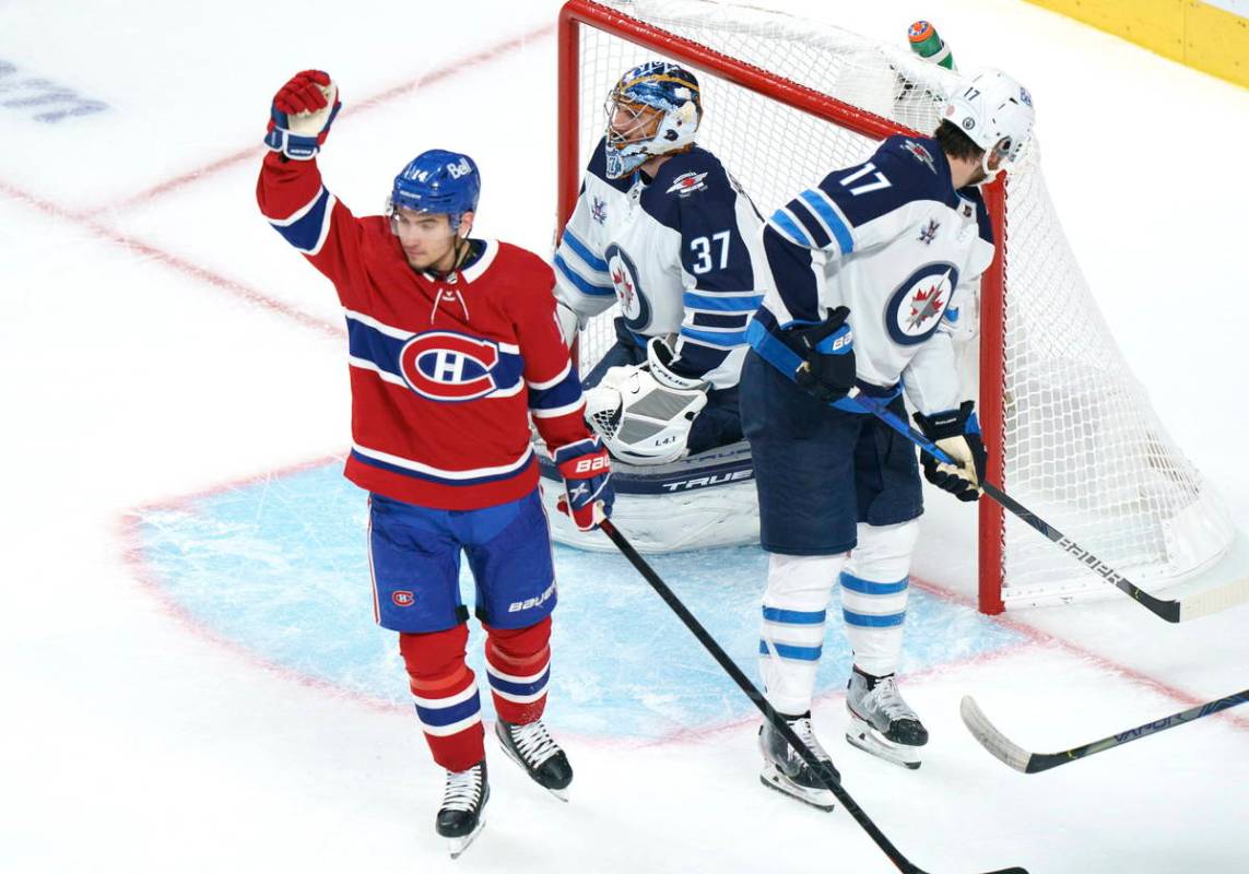Montreal Canadiens' Nick Suzuki celebrates his goal past Winnipeg Jets goaltender Connor Helleb ...