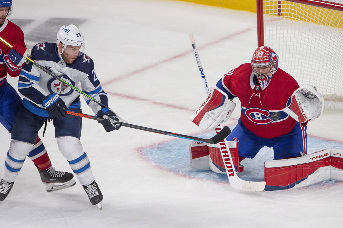 Montreal Canadiens goaltender Carey Price (31) keeps his eye on the puck as he stops Winnipeg J ...