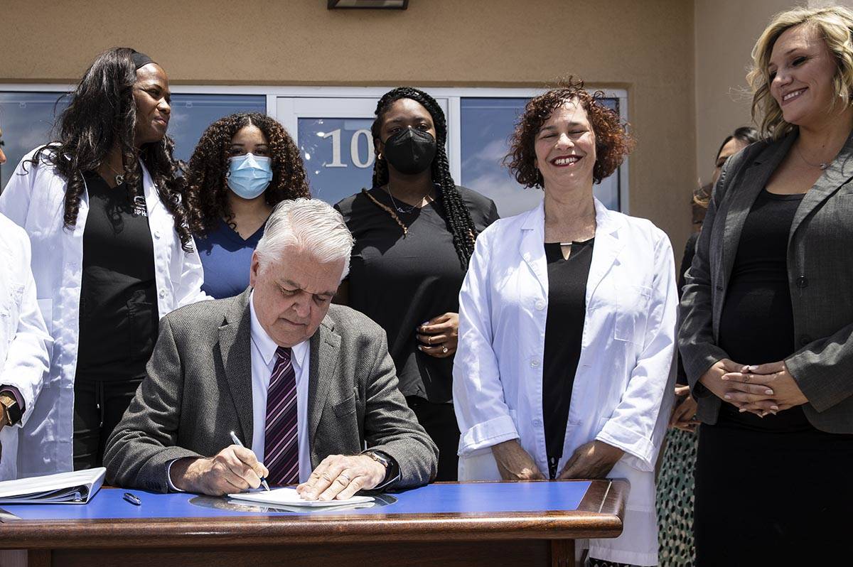 Gov. Steve Sisolak signs Senate Bill # 420, the bill that will provide a public health care opt ...