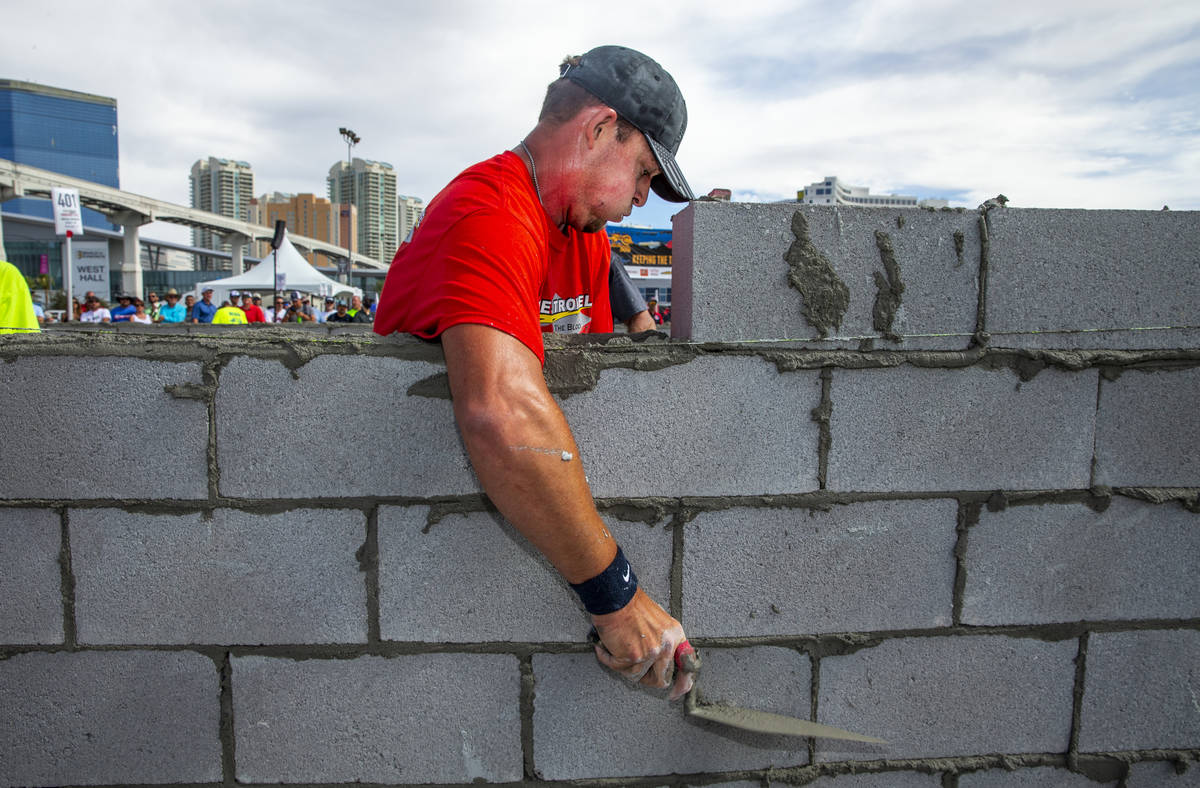 J.T. Payne of Cape Girardeau, MO., scrapes concrete off block in the Fastest Trowel on the Bloc ...