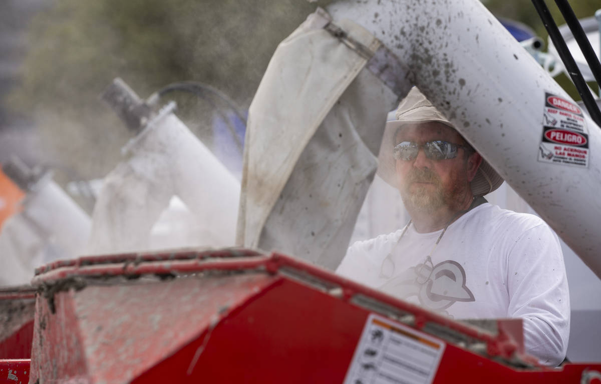 John Almond monitors the Spec Mix concrete mix used for the Fastest Trowel on the Block competi ...