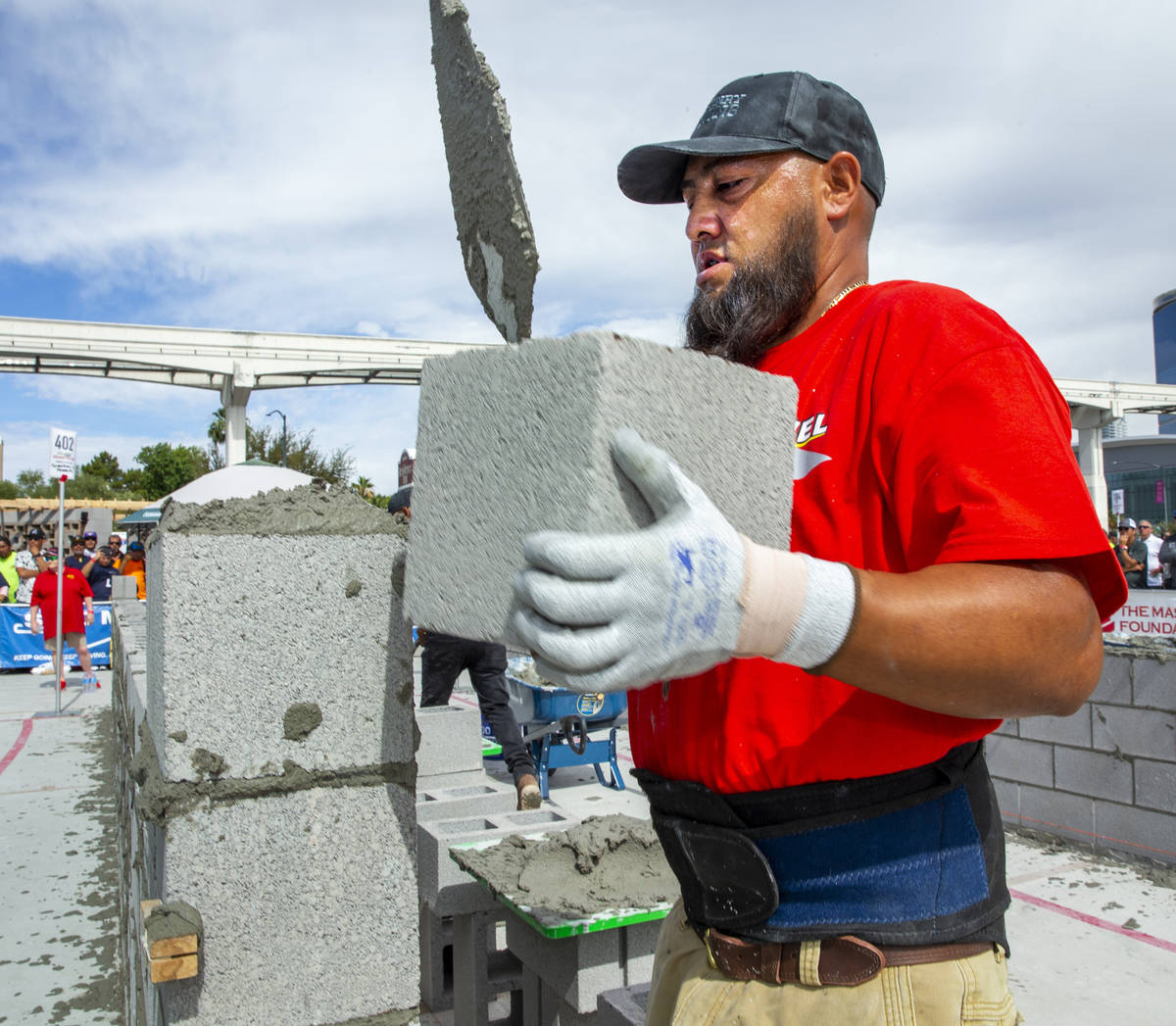 Gerardo Patlan of Phoenix, Arizona, stacks a concrete block in the Fastest Trowel on the Block ...