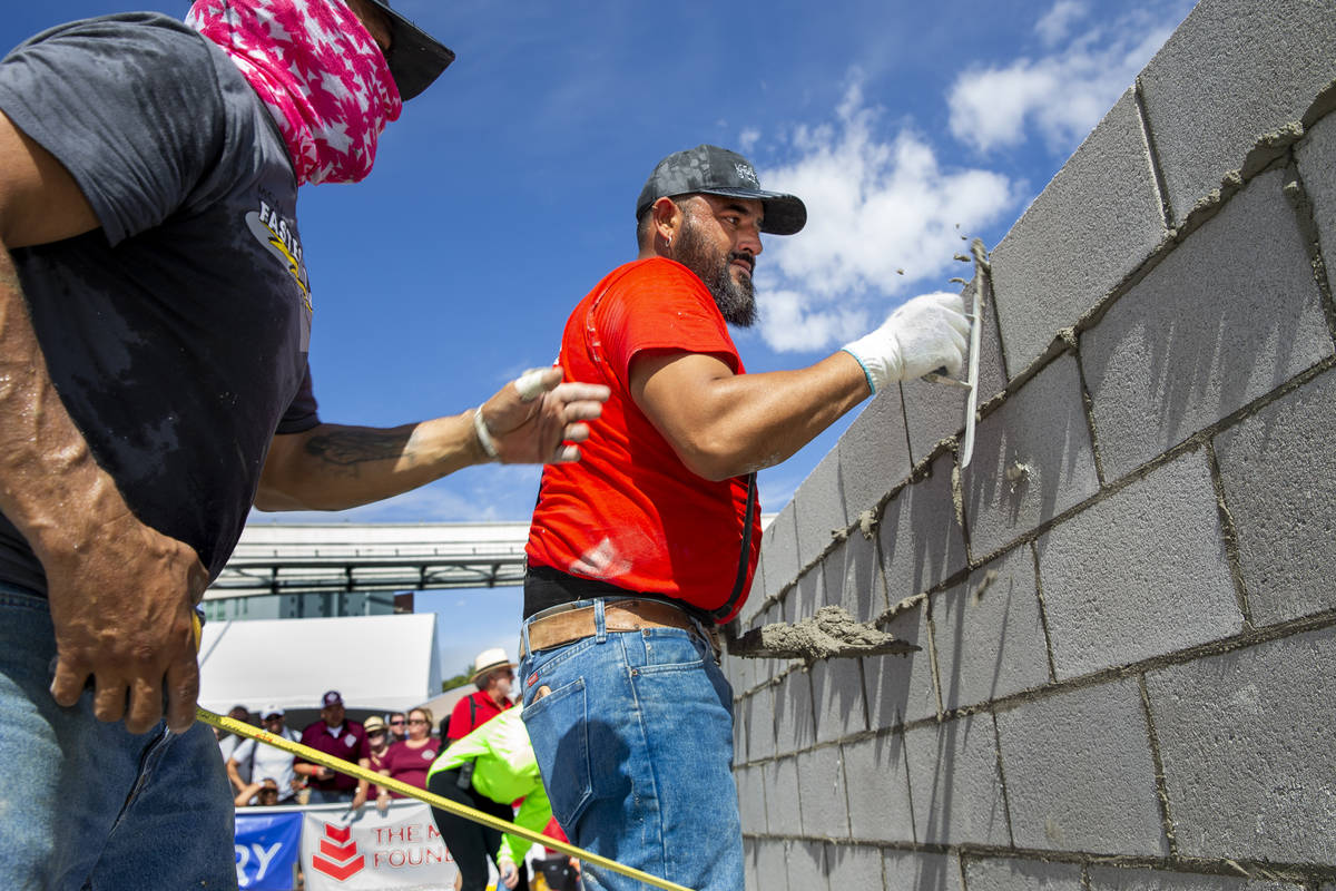 Jose Soto, right, and tender Israel Mendoza clean up concrete block in the Fastest Trowel on th ...