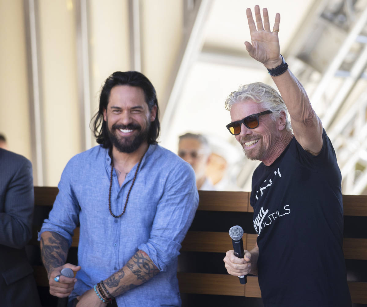 Sir Richard Branson, right, founder of Virgin Group, greets guests during the "Unstoppable ...