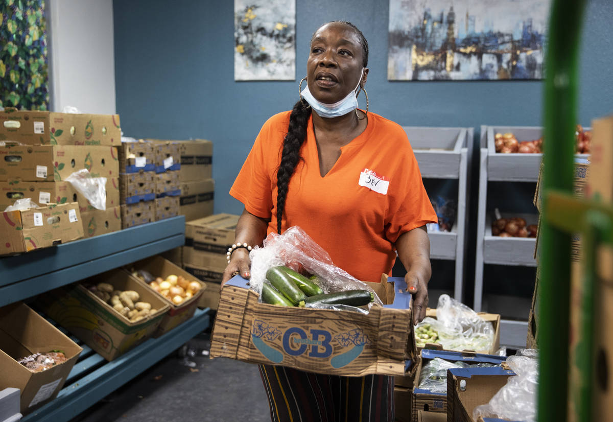 Volunteer Bev Anusionwu works in the food bank at City Impact Center on Tuesday, June 8, 2021, ...
