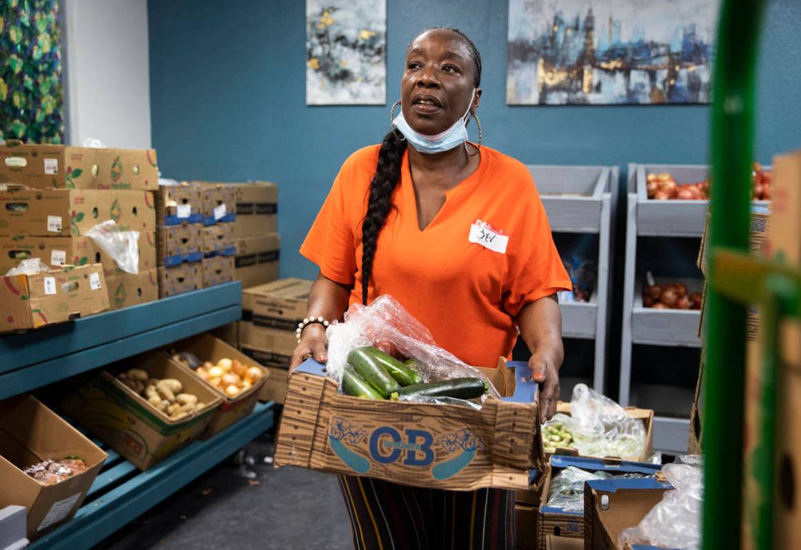 Volunteer Bev Anusionwu works in the food bank at City Impact Center on Tuesday, June 8, 2021, ...