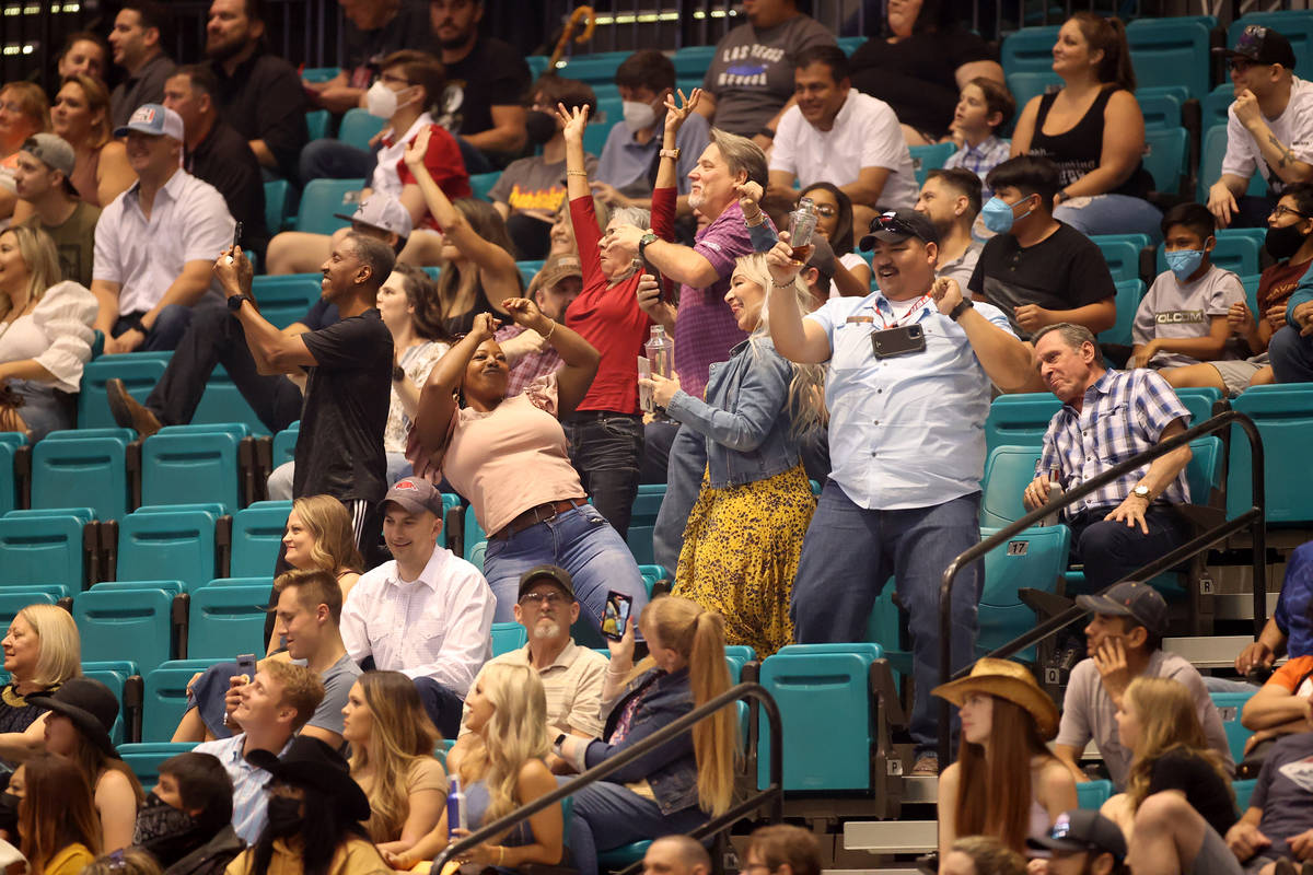 People dance during the Professional Bull Riders Las Vegas Invitational at the MGM Grand Garden ...