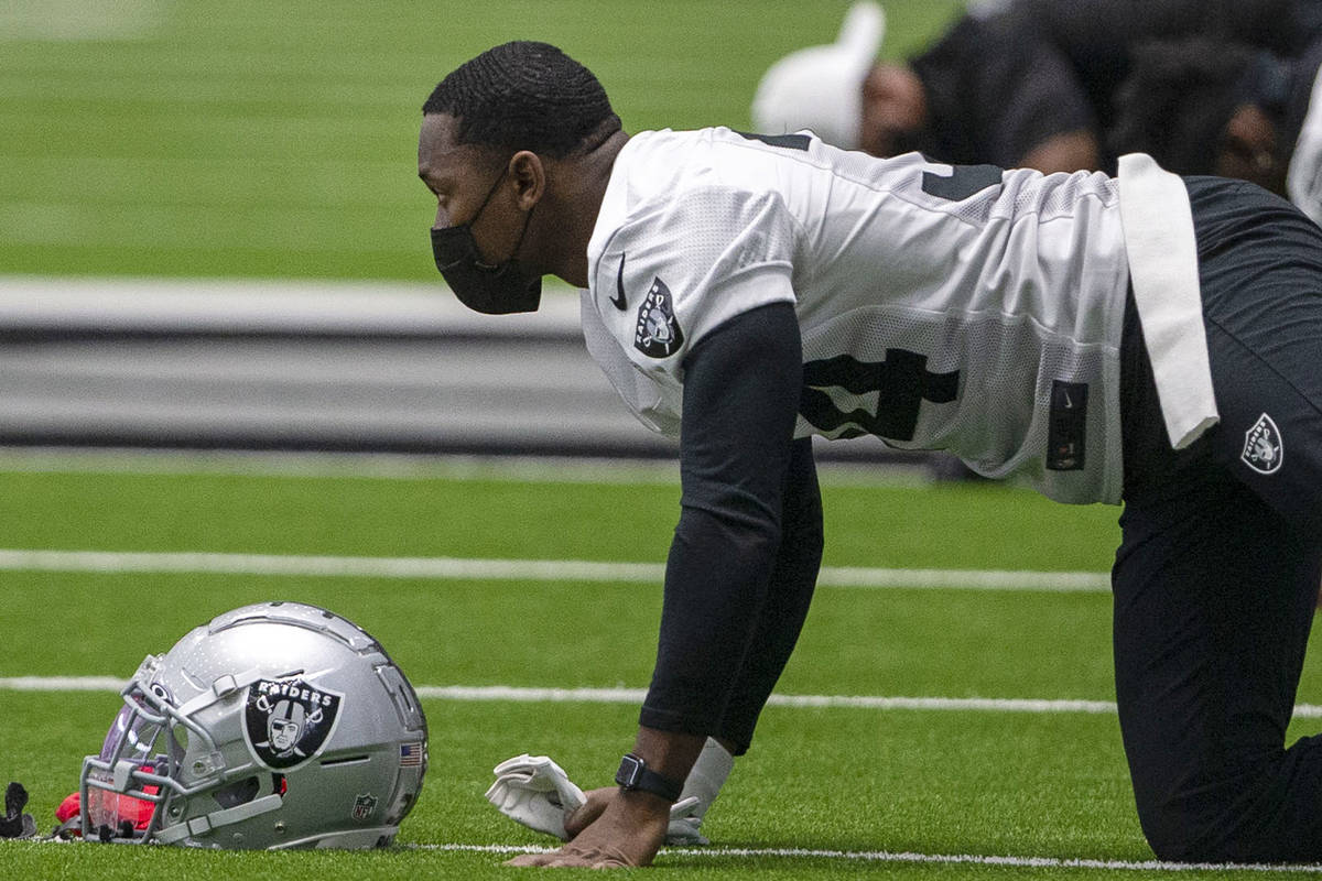 Las Vegas Raiders defensive back Kemah Siverand (34) wears a mask while stretching during a pra ...