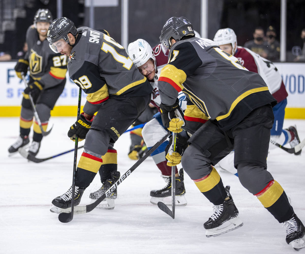 Golden Knights right wing Reilly Smith (19) and teammate center Jonathan Marchessault (81) sand ...