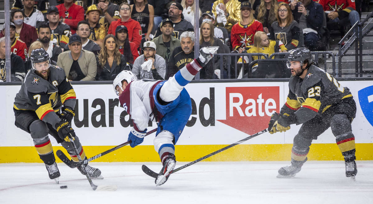 Colorado Avalanche right wing Mikko Rantanen (96) is upended between Golden Knights defenseman ...