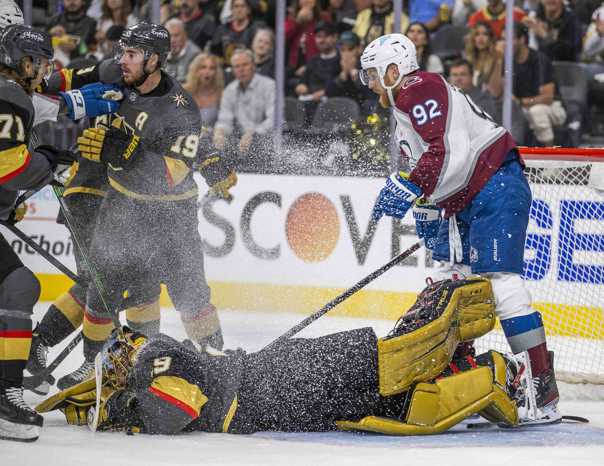 Golden Knights goaltender Marc-Andre Fleury (29)dives on the puck while defended by teammates o ...