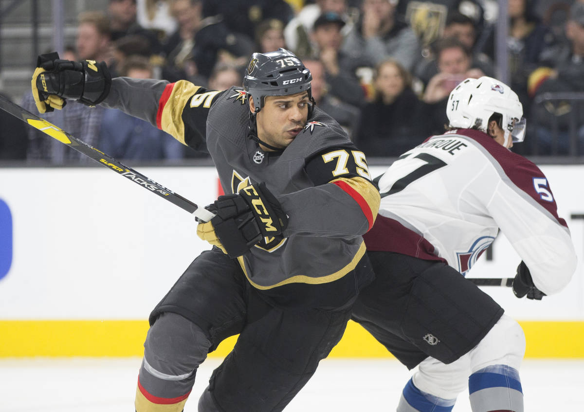 Golden Knights right wing Ryan Reaves (75) fights for position with Colorado Avalanche left win ...