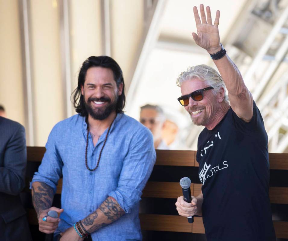 Sir Richard Branson, right, founder of Virgin Group, greets guests during the "Unstoppable ...