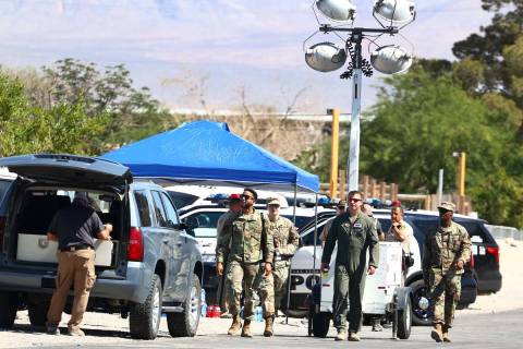 Military personnel investigate an airplane crash near Nellis Air Force Base, on Tuesday, May 25 ...