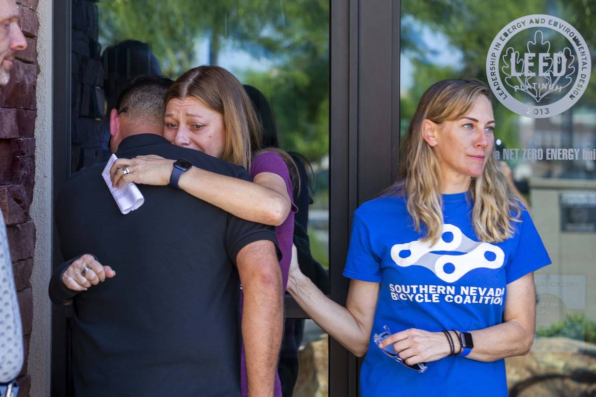 Angela Ahmet, center, hugs Rob Hutchinson, President of the Southern Nevada Bicycle Coalition, ...