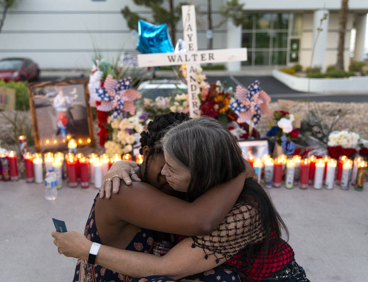 Joan Anderson, right, Walter Anderson's sister, hugs Charis Jimmons, his neighbor, at a vigil ...
