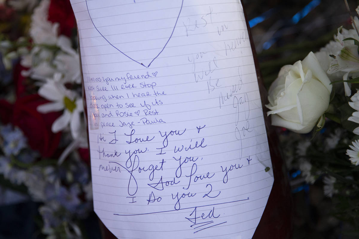 Loving notes are written at a vigil for Walter Richard Anderson near the intersection where he ...