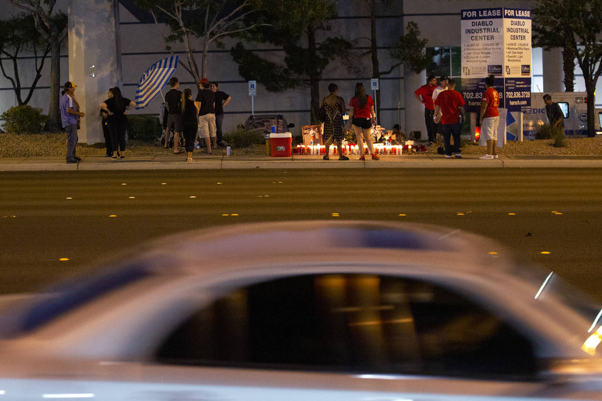 A car drives past a vigil for Walter Anderson near the intersection where he was killed, South ...