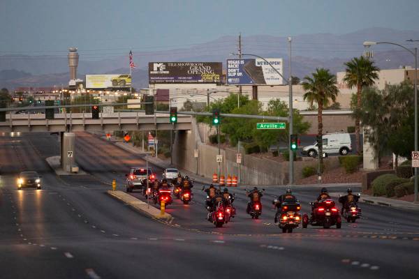 The Marine Riders Motorcycle Club drives away after attending a vigil for Walter Anderson near ...