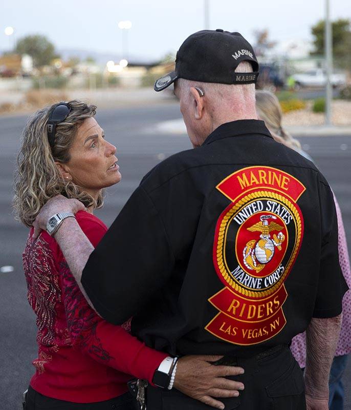 Lisa Anderson hugs her father John Anderson at a vigil for their brother and son Walter Anderso ...
