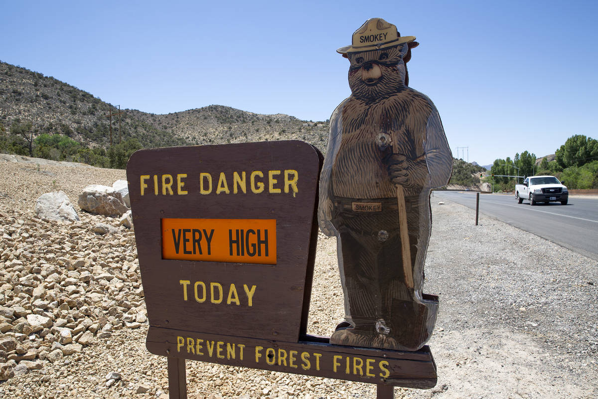 A Smokey the Bear sign indicates very high fire danger along State Route 160 on Saturday, June ...