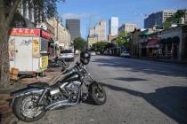 Road block barriers sit on the sidewalk on 6th Street after an early morning shooting on Saturd ...