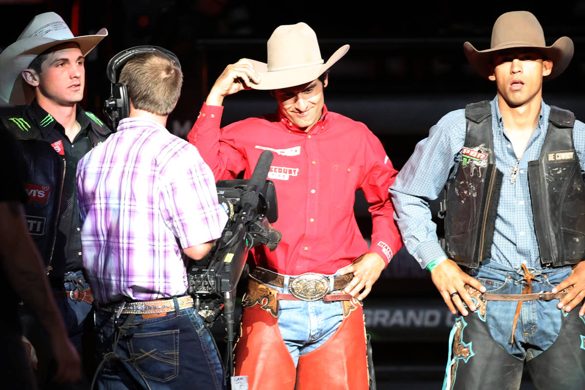 Bull rider Dener Barbosa, center, with Jo‹o Ricardo Vieira, left, and Silvano Alves, rig ...